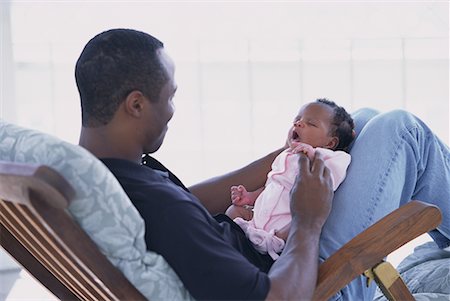 Father Sitting in Chair with Baby On Lap Stock Photo - Rights-Managed, Code: 700-00074764