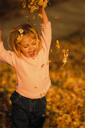 Girl Playing in Autumn Leaves Stock Photo - Rights-Managed, Code: 700-00075261