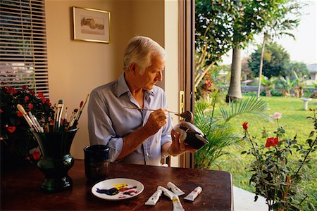 paint can - Mature homme assis dans la chaise peinture canard en bois Photographie de stock - Rights-Managed, Code: 700-00075275