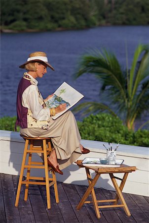 Mature Woman Sitting on Stool Painting Outdoors Fotografie stock - Rights-Managed, Codice: 700-00075291