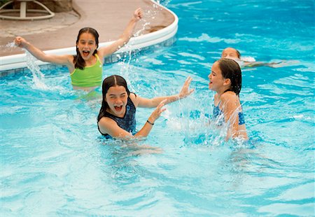 Girls in Swimwear, Playing in Swimming Pool Stock Photo - Rights-Managed, Code: 700-00075386