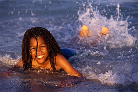 Portrait of Child Lying in Surf On Beach Stock Photo - Rights-Managed, Code: 700-00075460