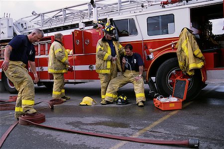 Group of Male Firefighters near Fire Truck Fotografie stock - Rights-Managed, Codice: 700-00076164