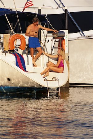 Mature Couple in Swimwear on Boat with Glasses of Wine Stock Photo - Rights-Managed, Code: 700-00076527