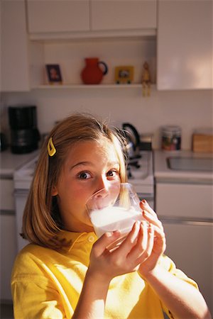 Portrait of Girl Drinking Glass Of Milk in Kitchen Stock Photo - Rights-Managed, Code: 700-00076629
