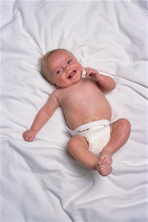 simsearch:700-00074902,k - Portrait of Smiling Baby Lying On Bed Stock Photo - Rights-Managed, Code: 700-00076899