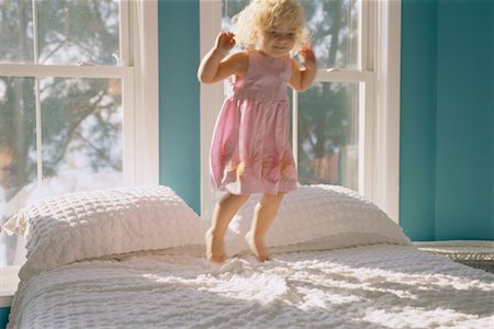 Girl Jumping on Bed Stock Photo - Rights-Managed, Code: 700-00077000