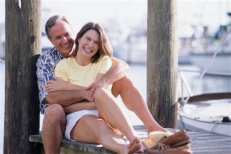 Portrait of Mature Couple Sitting On Dock near Marina Stock Photo - Rights-Managed, Code: 700-00077102