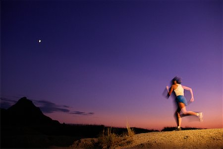 Blurred Back View of Woman Jogging at Dusk Stock Photo - Rights-Managed, Code: 700-00077213