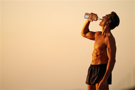 satisfied (thirst) - Man Drinking Water Outdoors Foto de stock - Con derechos protegidos, Código: 700-00077220