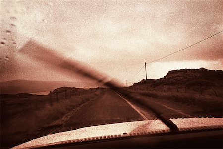 Blurred View of Windshield Wiper Moving on Windshield in Rain Fotografie stock - Rights-Managed, Codice: 700-00077427