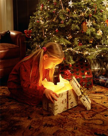 Girl Sitting on Floor, Opening Christmas Gift Stock Photo - Rights-Managed, Code: 700-00077714