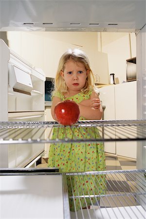 Portrait of Girl Looking at Apple in Fridge Stock Photo - Rights-Managed, Code: 700-00077716