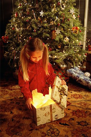 Girl Sitting on Floor, Opening Christmas Gift Stock Photo - Rights-Managed, Code: 700-00077712