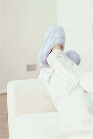 feet sofa comfort - Woman's Feet in Slippers Hanging over Edge of Sofa Stock Photo - Rights-Managed, Code: 700-00077850