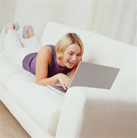 simsearch:700-00053035,k - Woman Lying on Sofa, Using Laptop Computer Stock Photo - Rights-Managed, Code: 700-00078187