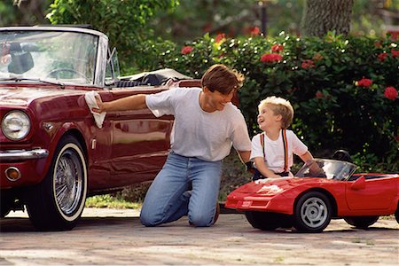 Father Polishing Car with Son Polishing Toy Car Stock Photo - Rights-Managed, Code: 700-00078276