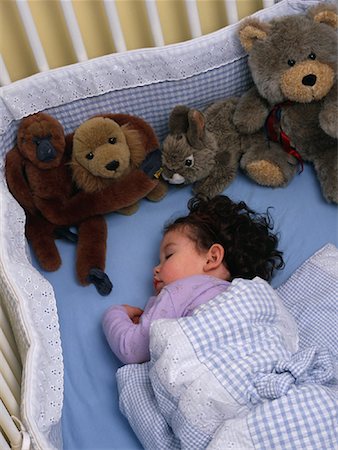 Girl Sleeping in Crib with Stuffed Animals Stock Photo - Rights-Managed, Code: 700-00078701