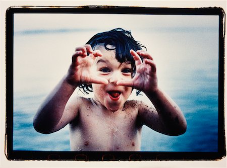 simsearch:700-00045320,k - Portrait of Child Standing in Water, Making Face and Hand Gesture Stock Photo - Rights-Managed, Code: 700-00078729