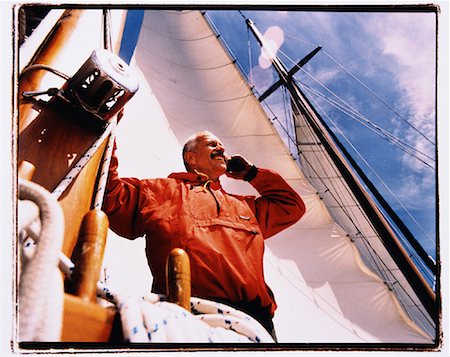 simsearch:700-00424633,k - Mature Man Using Cell Phone on Sailboat Stock Photo - Rights-Managed, Code: 700-00079118