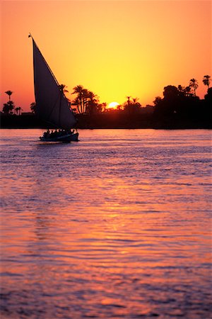 egyptian sailing on nile river - Felucca on River Nile at Sunset Luxor, Egypt Stock Photo - Rights-Managed, Code: 700-00079176