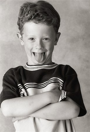 simsearch:700-00045320,k - Portrait of Boy with Arms Crossed Sticking Tongue Out Stock Photo - Rights-Managed, Code: 700-00079191