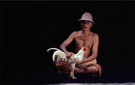 Portrait of Man with Rooster Bali, Indonesia Stock Photo - Rights-Managed, Code: 700-00079474
