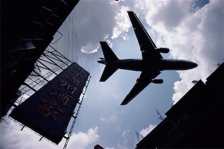 Looking Up at Airplane from Street in Chinatown Hong Kong Stock Photo - Rights-Managed, Code: 700-00079549