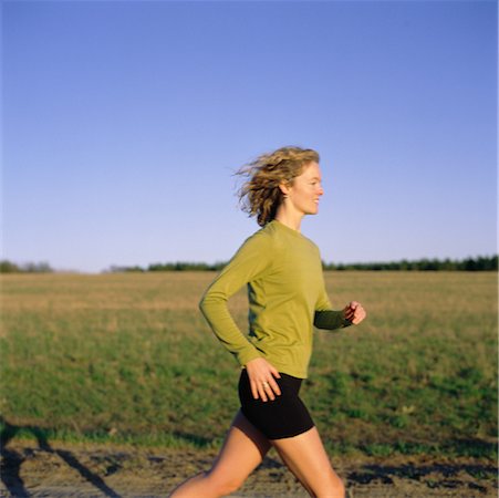 Woman Running on Dirt Road Fotografie stock - Rights-Managed, Codice: 700-00079772