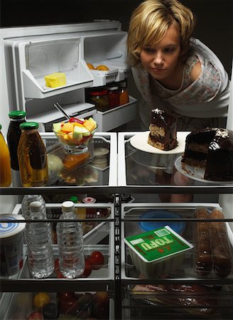 Woman Looking at Fruit Salad in Fridge with Chocolate Cake, Tofu And Juice Stock Photo - Rights-Managed, Code: 700-00079957