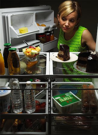 simsearch:700-00077881,k - Woman Looking at Fruit Salad in Fridge with Chocolate Cake, Tofu And Juice Stock Photo - Rights-Managed, Code: 700-00079961