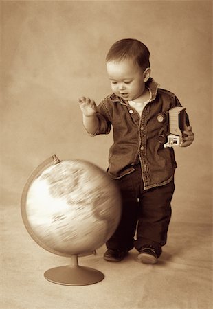 Boy Standing near Spinning Globe Stock Photo - Rights-Managed, Code: 700-00070704