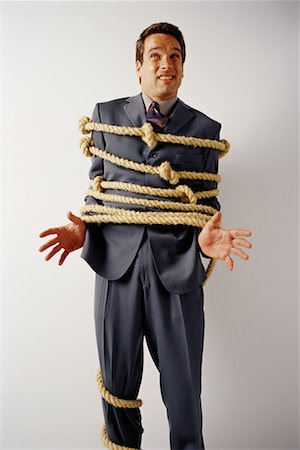 rehén - Portrait of Businessman Tied with Knotted Rope Foto de stock - Con derechos protegidos, Código: 700-00070813