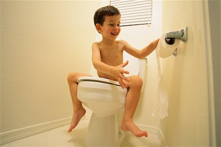 Nude Boy Sitting on Toilet Unrolling Toilet Paper Stock Photo - Rights-Managed, Code: 700-00070918