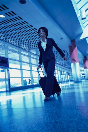 simsearch:700-00071171,k - Businesswoman Walking in Terminal Pulling Luggage Stock Photo - Rights-Managed, Code: 700-00071166