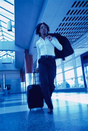 simsearch:700-00071171,k - Businesswoman Walking in Terminal Pulling Luggage Stock Photo - Rights-Managed, Code: 700-00071162