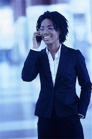 simsearch:700-00071171,k - Businesswoman Using Cell Phone Smiling in Terminal Stock Photo - Rights-Managed, Code: 700-00071175