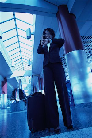 simsearch:700-00071171,k - Businesswoman Standing in Terminal, Checking Watch, Using Cell Phone Stock Photo - Rights-Managed, Code: 700-00071171