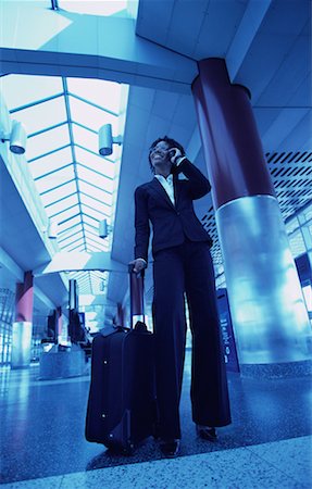 simsearch:700-00071171,k - Businesswoman Standing in Terminal with Luggage, Using Cell Phone Stock Photo - Rights-Managed, Code: 700-00071172