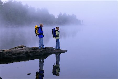 Couple Standing on Rocks in Lake With Fog, Haliburton, Ontario Canada Stock Photo - Rights-Managed, Code: 700-00071200