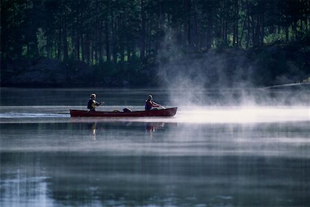 Couple Canoeing on Lake with Mist Haliburton, Ontario, Canada Stock Photo - Rights-Managed, Code: 700-00071212