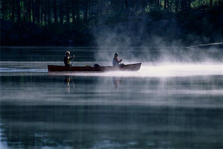 Couple Canoeing on Lake with Mist Haliburton, Ontario, Canada Stock Photo - Rights-Managed, Code: 700-00071213