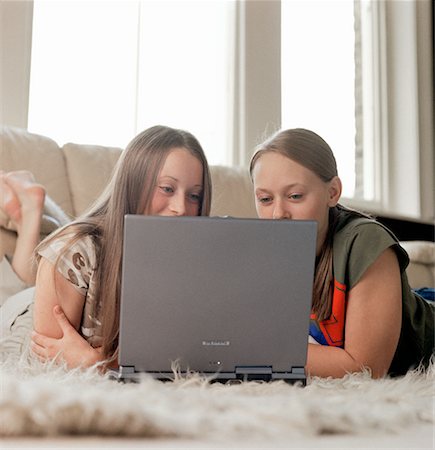 preteen girl lying on - Two Teenage Girls Lying on Floor Using Laptop Computer Stock Photo - Rights-Managed, Code: 700-00071693