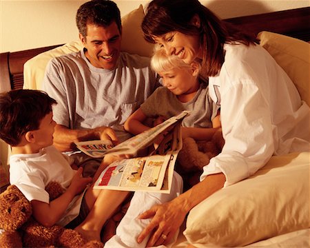 Family Reading Comics in Bed Stock Photo - Rights-Managed, Code: 700-00071747