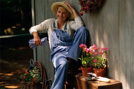 simsearch:700-01172940,k - Portrait of Woman Sitting by House with Gardening Supplies Stock Photo - Rights-Managed, Code: 700-00072219