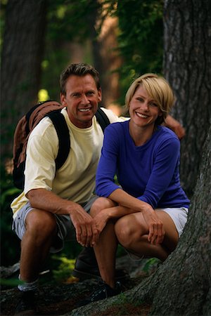 female hiker crouching - Portrait of Couple Crouching in Forest Stock Photo - Rights-Managed, Code: 700-00072240