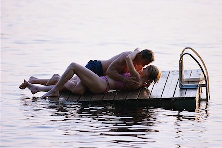 floating dock - Couple in Swimwear, Lying on Floating Dock Face to Face Embracing Stock Photo - Rights-Managed, Code: 700-00072243