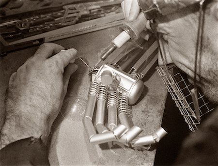 robotic arm - Close-Up of Man Building Robotic Hand Stock Photo - Rights-Managed, Code: 700-00072419