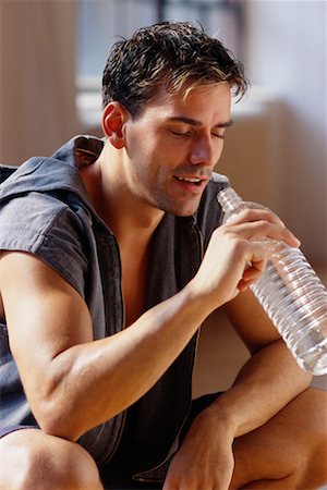satisfied (thirst) - Man Drinking Bottle of Water Foto de stock - Con derechos protegidos, Código: 700-00072486