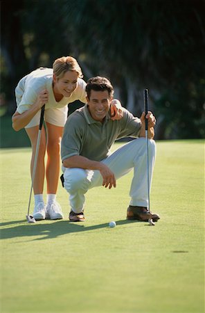 Couple Golfing, Woman Helping Man Line Up Putt Stock Photo - Rights-Managed, Code: 700-00073003